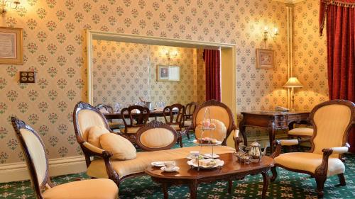 a dining room with chairs and a table and a mirror at Crowne Plaza - Sheffield by IHG in Sheffield