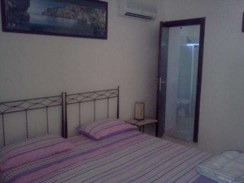 a bedroom with a bed with pink pillows on it at b&b Bellavista in Castro di Lecce