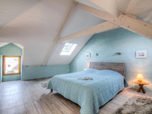 a bedroom with a large bed in a attic at Holiday Home Hoche by Interhome in Kerhostin