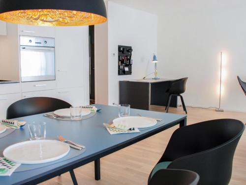 a blue table with plates and chairs in a kitchen at Apartment LaVille A-3-4 by Interhome in Locarno