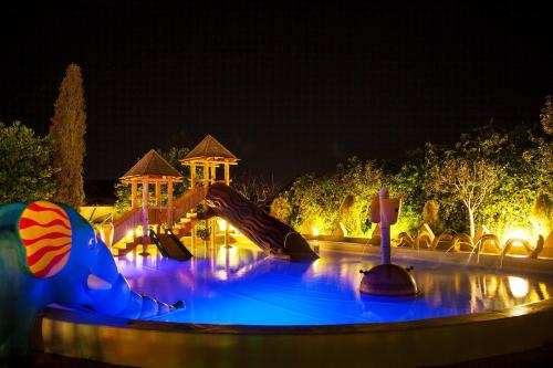 a water park at night with a slide at Augusta Eco Wellness Resort 4 Superior in Sanxenxo