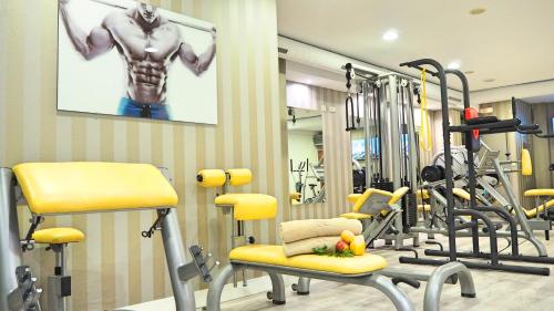 a gym with a bunch of exercise equipment in it at Augusta Eco Wellness Resort 4 Superior in Sanxenxo