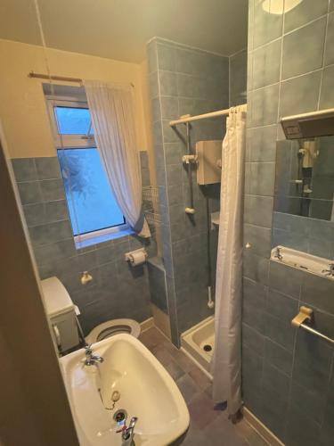 a bathroom with a sink and a toilet and a shower at Highbury Hotel in Blackpool
