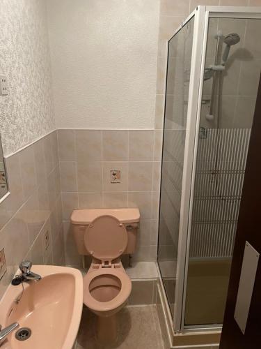 a bathroom with a toilet and a sink and a shower at Highbury Hotel in Blackpool