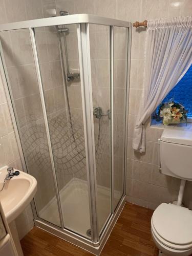 a shower stall in a bathroom with a toilet at Highbury Hotel in Blackpool
