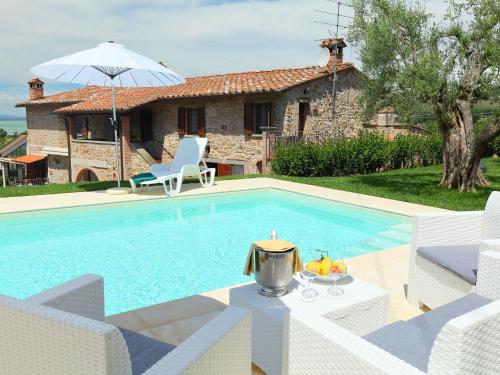 a villa with a swimming pool and a house at Holiday Home Trasimeno link by Interhome in San Savino