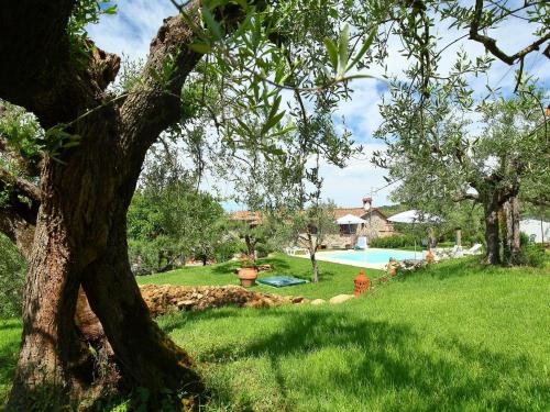 a tree in a yard with a swimming pool at Holiday Home Trasimeno link by Interhome in San Savino