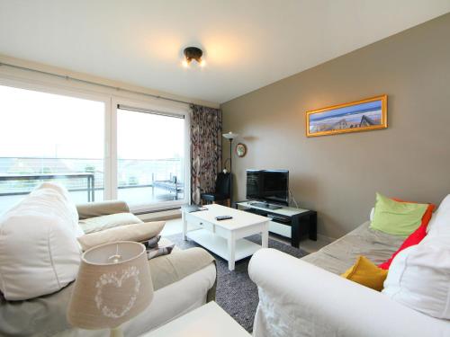 a living room with two couches and a tv at Apartment Greens 103 with parking by Interhome in Mispelburg