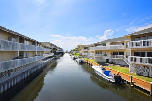a river with buildings and boats on it at Sandpiper Cove by Panhandle Getaways in Destin