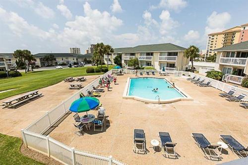 a swimming pool with lounge chairs and umbrellas at Sandpiper Cove by Panhandle Getaways in Destin