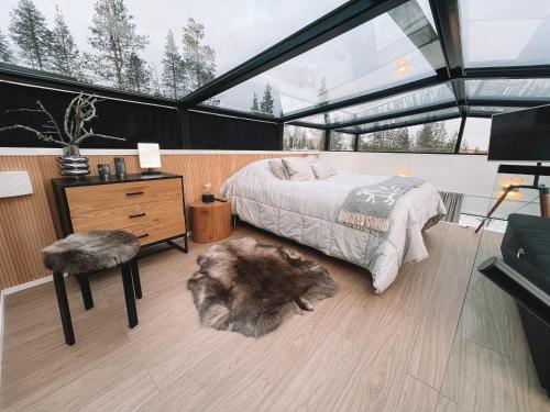 a bedroom with a bed and a large window at Levi Sensu - Levi Sky Igloos in Sirkka