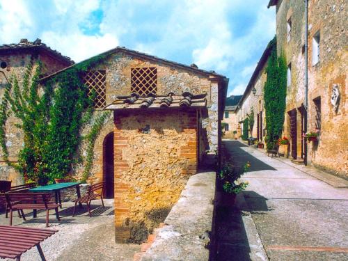 an alley in an old stone building with a table at Apartment L'Erika by Interhome in Cetinale