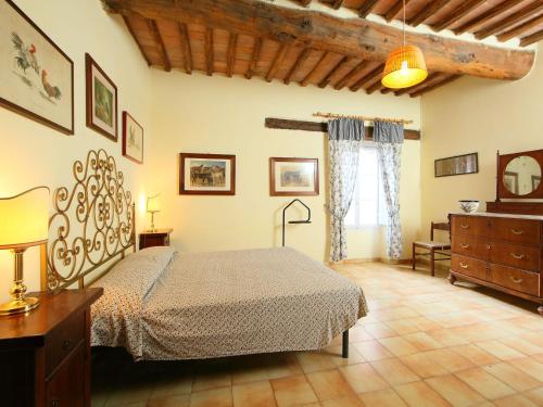 a bedroom with a bed and a dresser in it at Apartment L'Erika by Interhome in Cetinale