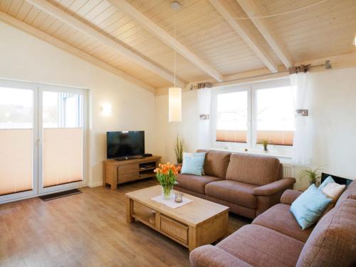 a living room with two couches and a tv at Holiday Home Langeneß by Interhome in Dagebüll