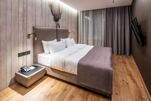 a bedroom with a large bed and a night stand at Loft7 in Lviv