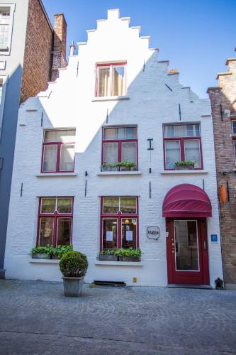 a white building with a staircase on the side of it at Hotel Bla Bla in Bruges