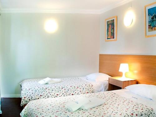 a hotel room with two beds and a lamp at Apartment T2 by Interhome in Sintra