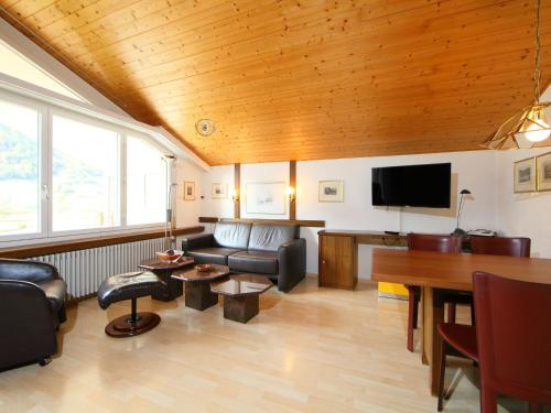a living room with a couch and a table at Apartment Ringstrasse - Utoring-46 by Interhome in Leukerbad