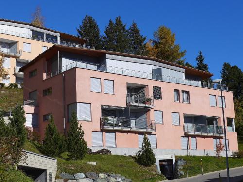 an apartment building on a hill with trees at Apartment Chesa Crusch 7 by Interhome in Samedan