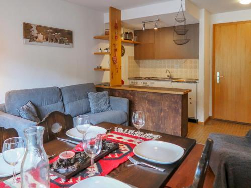 a living room with a table with plates and wine glasses at Apartment Beau-Séjour 24 by Interhome in Nendaz