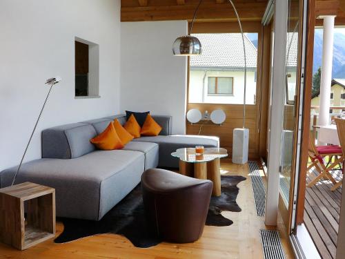 a living room with a couch and a table at Apartment Chesa Vadret 12 by Interhome in Pontresina