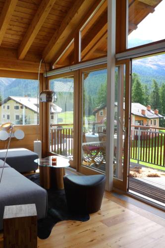 a living room with a large window with a view at Apartment Chesa Vadret 12 by Interhome in Pontresina