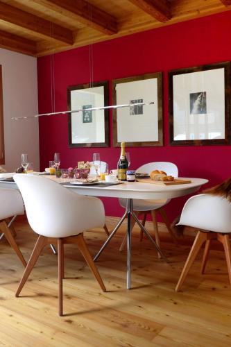 a dining room with a white table and chairs at Apartment Chesa Vadret 12 by Interhome in Pontresina