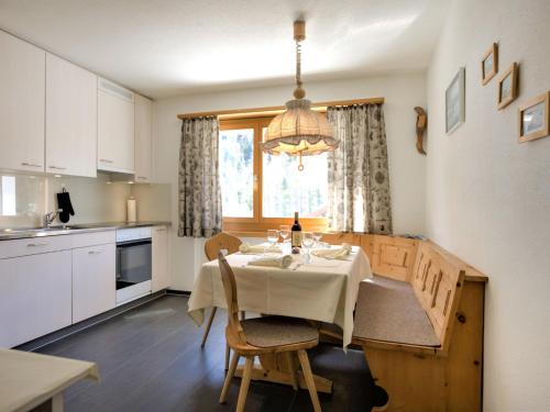 a kitchen with a table with a white table cloth at Apartment Chesa Islas by Interhome in Pontresina