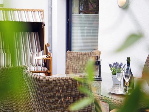 a table with a bottle of wine and two glasses at Apartment Witthuus-Juist by Interhome in Norddeich