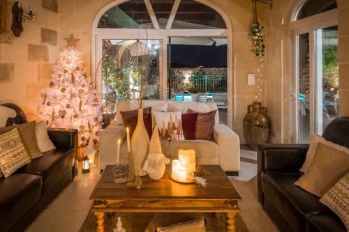 a living room with a christmas tree and a couch at Sweet Life Gozo - Boutique Living in Santa Luċija