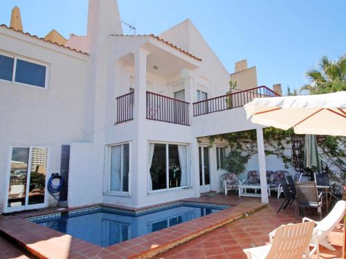 a house with a swimming pool in front of it at Holiday Home Mar y Montaña by Interhome in Benidorm