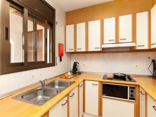 a kitchen with a sink and a microwave at Apartment Adelfa apt 6 by Interhome in Sant Martí d'Empúries