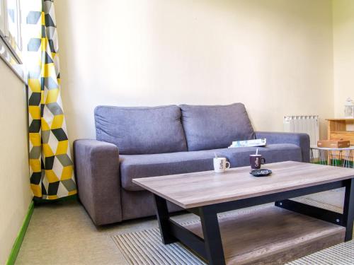 a living room with a couch and a coffee table at Studio Gentiane-5 by Interhome in Chamonix-Mont-Blanc