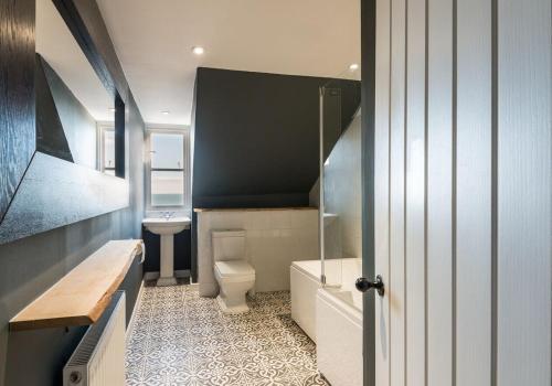 a bathroom with a toilet and a sink at SeaView Loft in Dunbar