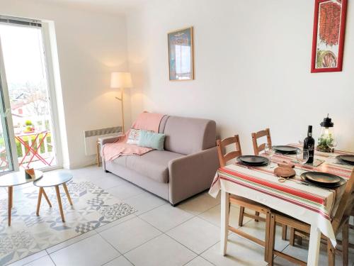 a living room with a couch and a table at Apartment Berasteguia-2 by Interhome in Saint-Jean-de-Luz