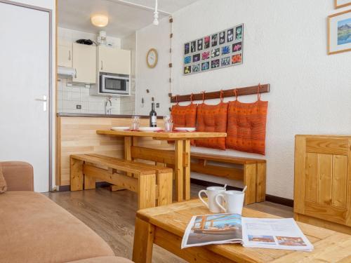 a living room with a table and a kitchen at Studio Les Tommeuses - Val Claret-27 by Interhome in Tignes