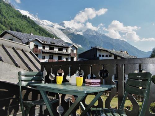 - une table avec deux chaises et des boissons sur un balcon avec des montagnes dans l'établissement Studio Le Chailloud-4 by Interhome, à Chamonix-Mont-Blanc