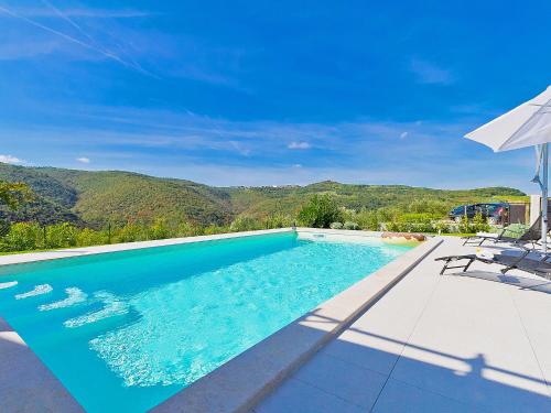 a swimming pool with a view of the mountains at Holiday Home Ravan by Interhome in Brkač