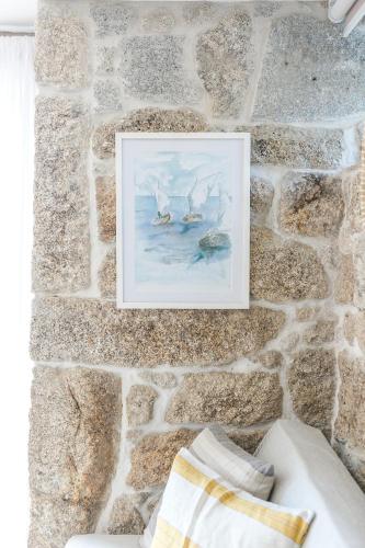 a painting of boats on a stone wall at Casa Monte do Cervo in Vila Nova de Cerveira