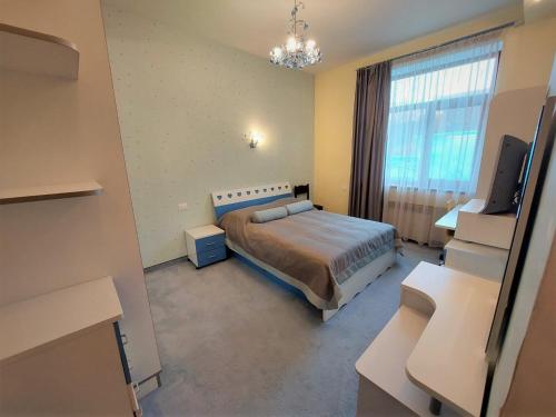 a bedroom with a bed and a flat screen tv at Nat Craft - Вилла Гарден in Tsaghkadzor