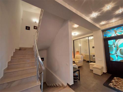 a staircase in a house with a living room at Nat Craft - Вилла Гарден in Tsaghkadzor