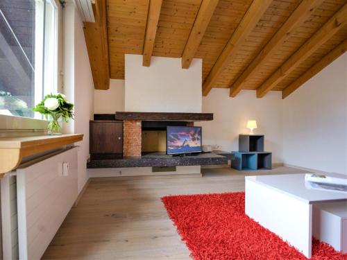 a living room with a fireplace and a red rug at Apartment Granit-5 by Interhome in Zermatt