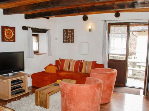 a living room with a couch and a tv at Holiday Home Rustico Cristallo by Interhome in Aquila