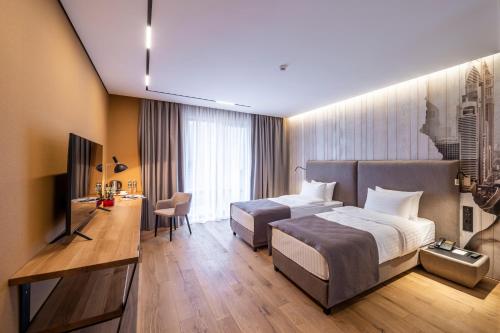a hotel room with two beds and a television at Loft7 in Lviv