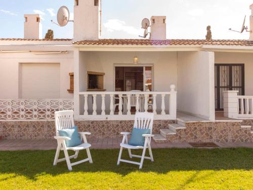 two chairs on the front yard of a house at Holiday Home Salvagina 53 by Interhome in Riumar