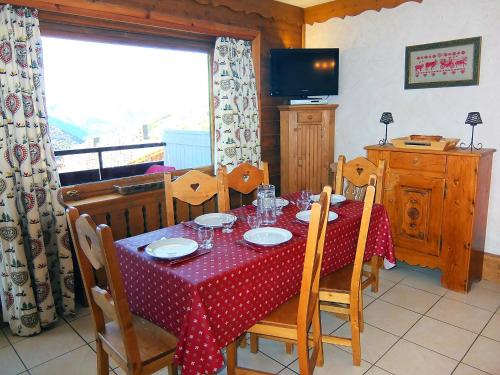 a dining room table with a red and white polka dot table cloth at Apartment L'Oisans by Interhome in Les Menuires