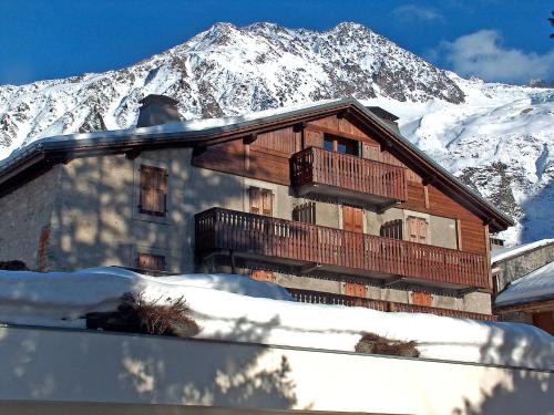 a house in the snow with a snow covered mountain at Apartment Chalet Le Tour by Interhome in Chamonix-Mont-Blanc