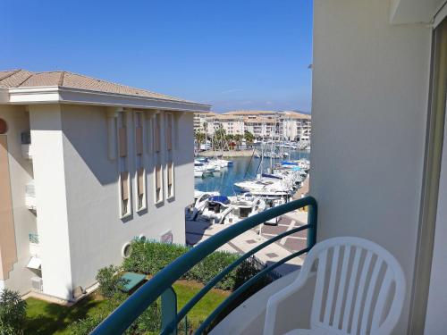 a balcony with a view of a marina with boats at Apartment L'Open-6 by Interhome in Fréjus