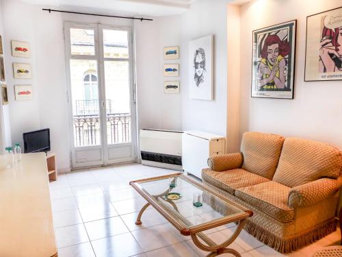 a living room with a couch and a glass table at Apartment Le Concordia by Interhome in Nice