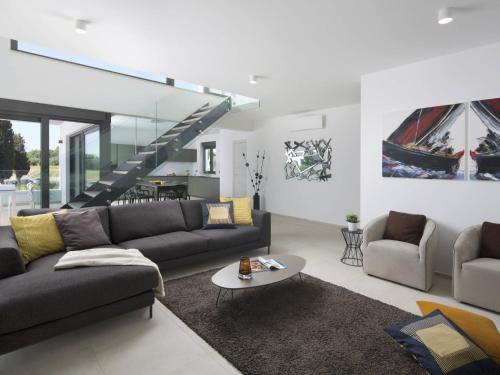 a living room with a couch and a table at Apartment Villa Fasana by Interhome in Fažana